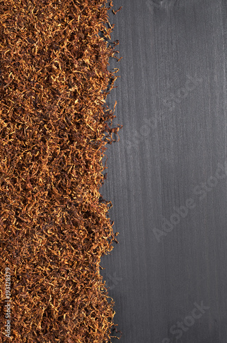 Fotografie Cigarette tobacco on a black