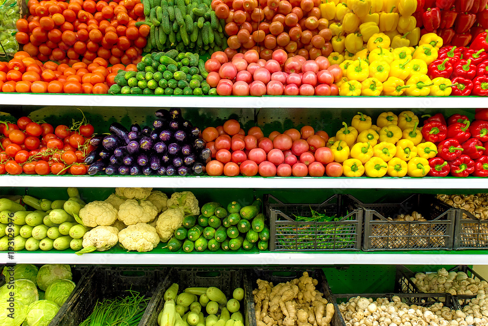 Fresh organic Vegetables and fruits on shelf in supermarket, farmers market. Healthy food concept. Vitamins and minerals. Tomatoes, capsicum, cucumbers, mushrooms, zucchini,