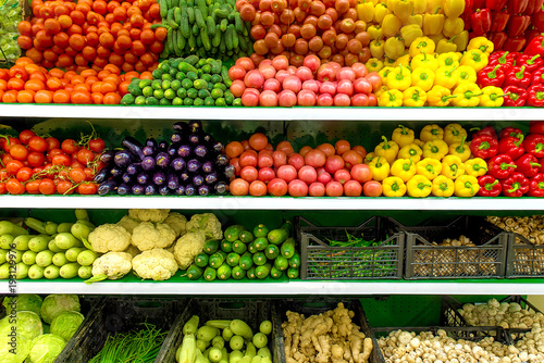 Fresh organic Vegetables and fruits on shelf in supermarket, farmers market. Healthy food concept. Vitamins and minerals. Tomatoes, capsicum, cucumbers, mushrooms, zucchini,