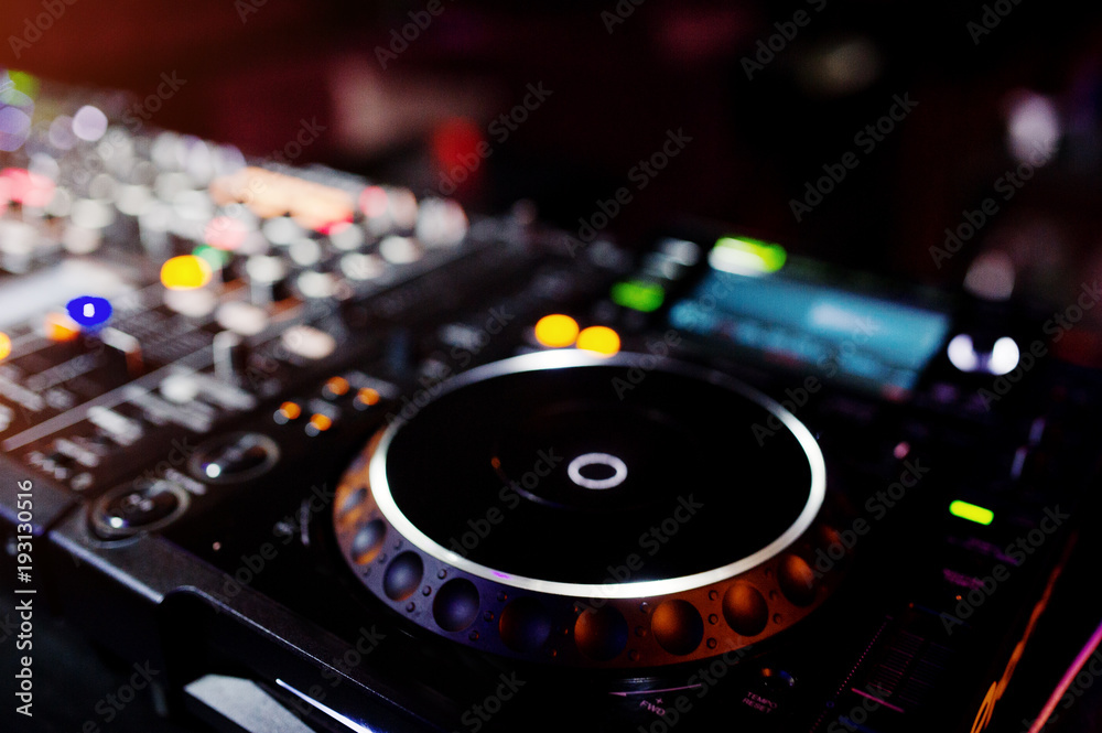 DJ spinning mixing and scratching track controls on dj's deck strobe. Dj Music club life concept