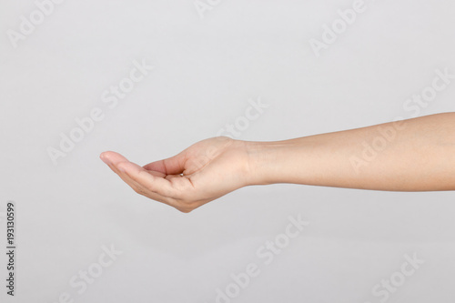 Hand  is show gesture reached up or hold something on white background. . © charupha