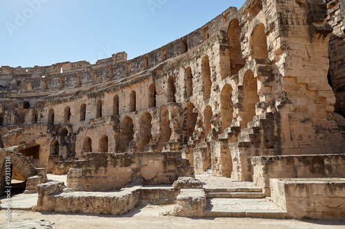 The impressive ruins of the largest colosseum in North Africa, a huge Roman amphitheater in the small village of El Jem, Tunisia.
