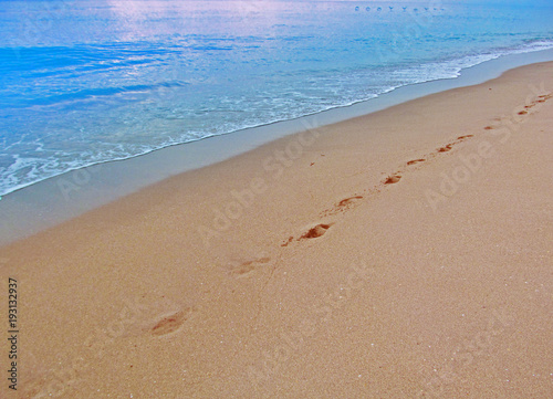 Abstract human footprints on sand beach.  View of the sand and water on the beach in Miami  Florida  USA.Travel vacation concept.