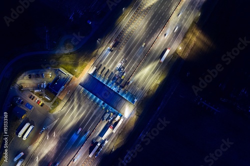 Aerial drone view on toll collection point on motorway at night.