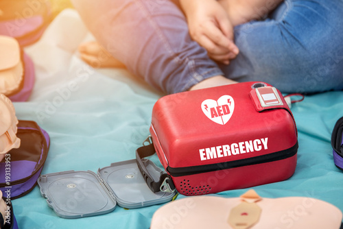 Automated External Defibrillator (AED) Box on the Mat in Emergency CPR Training Course - First Aid Concept photo