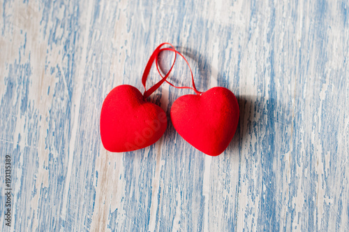 Two red hearts on a blue wooden background. Holiday Valentine's Day, wedding