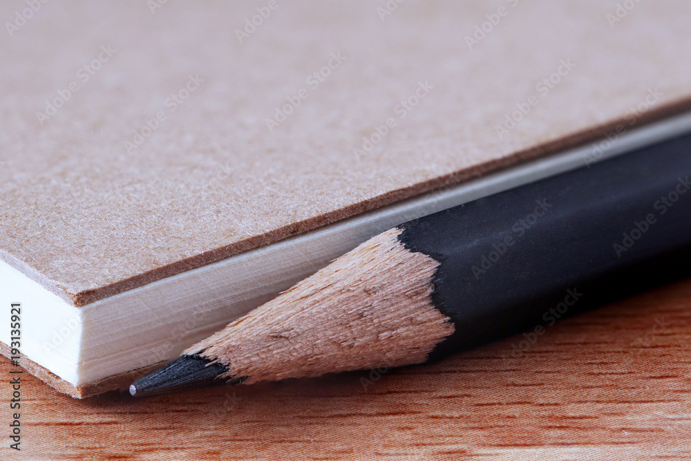 Note book cover with recycle paper on wooden table, copy space for text backgrounds Note book cover with recycle paper on wooden table, copy space for text backgrounds