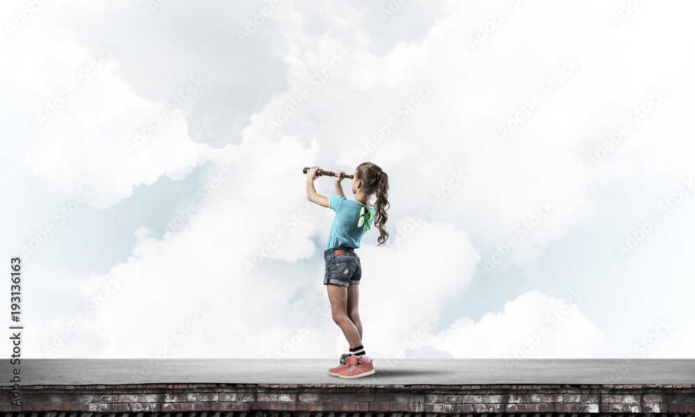 Concept of careless happy childhood with girl exploring this wor Concept of careless happy childhood with girl exploring this wor
