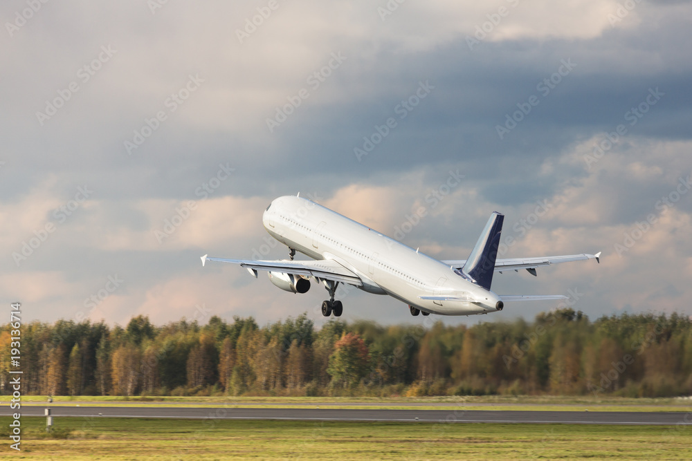 Narrow-body passenger airplane fly up over take-off runway from airport at sunset, copy space, side view, in motion/ Vacation, aviation, travel, trip - concept/ blurred background/ Departure board Narrow-body passenger airplane fly up over take-off runway from airport at sunset, copy space, side view, in motion/ Vacation, aviation, travel, trip - concept/ blurred background/ Departure board