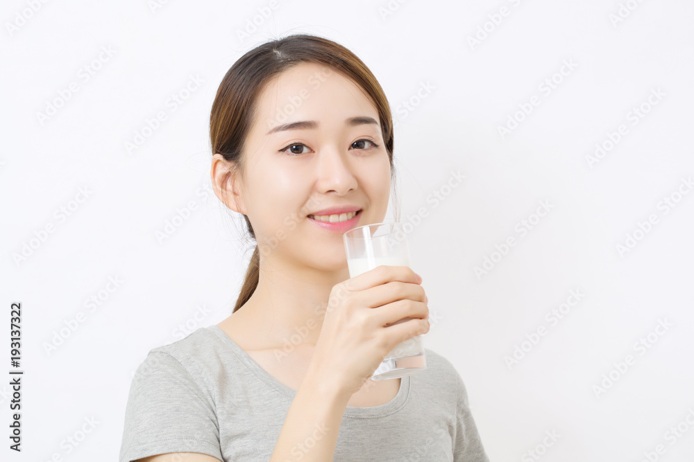 Woman drinking milk. Happy and smiling beautiful young woman enjoying a glass milk. Woman drinking milk. Happy and smiling beautiful young woman enjoying a glass milk.
