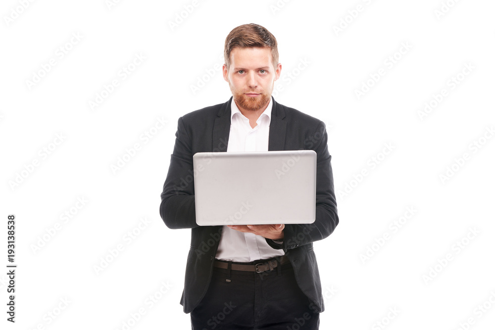Studio portrait of young manager in suit holding open laptop Studio portrait of young manager in suit holding open laptop