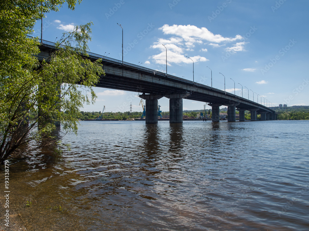 Long concrete bridge across the wide river