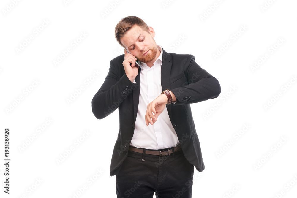 Portrait of young businessman with mobile phone on white background