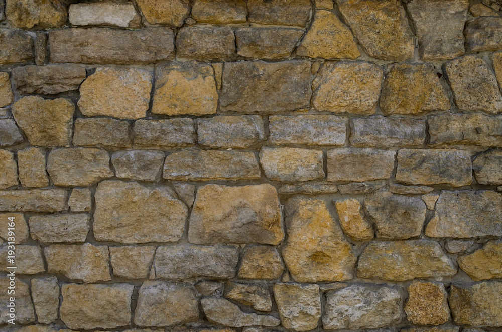 Fragment of the stone wall of the ancient fortress