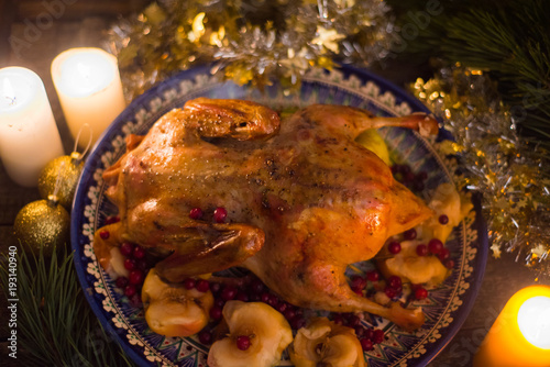 Roasted Turkey. Thanksgiving table served with turkey, decorated with bright autumn leaves and candles. Roasted chicken, table setting. Christmas dinner