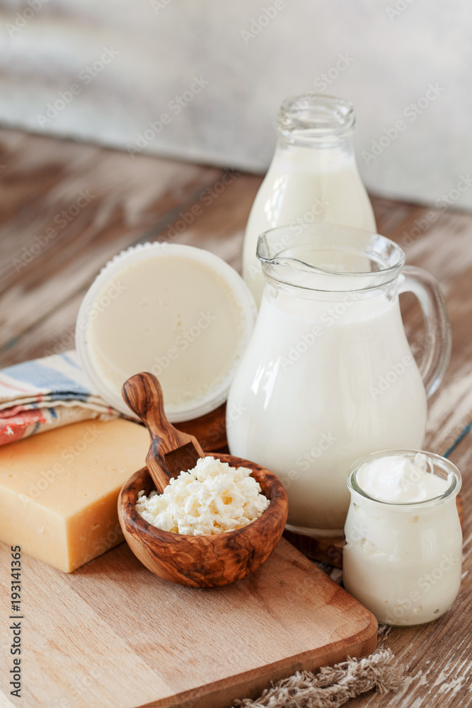 Set of different milk products on ristic wooden table Set of different milk products on ristic wooden table