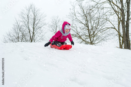 Girl with sleds outdoors on winter day