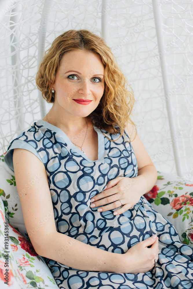 beautiful Pregnant woman sits on swing at home beautiful Pregnant woman sits on swing at home