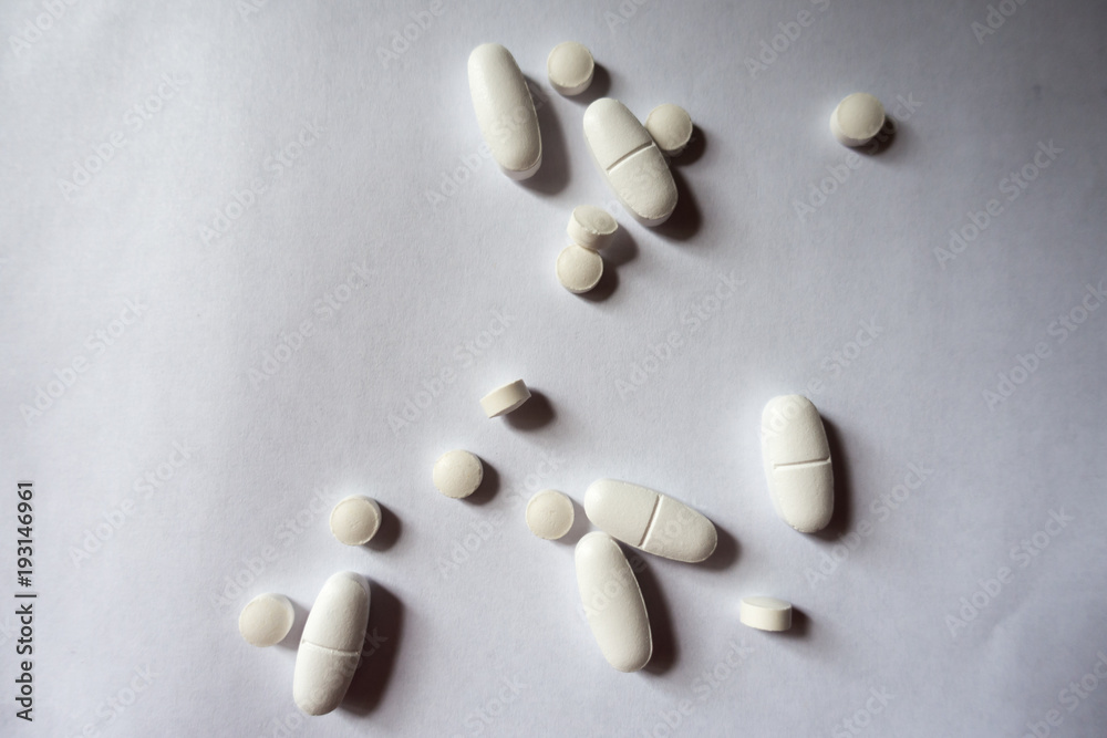 Oblong caplets of calcium citrate and round tablets of vitamin K2 Oblong caplets of calcium citrate and round tablets of vitamin K2