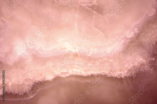 Lightened slices marble onyx. Horizontal image. Warm pink and yellow colors. Beautiful close up background