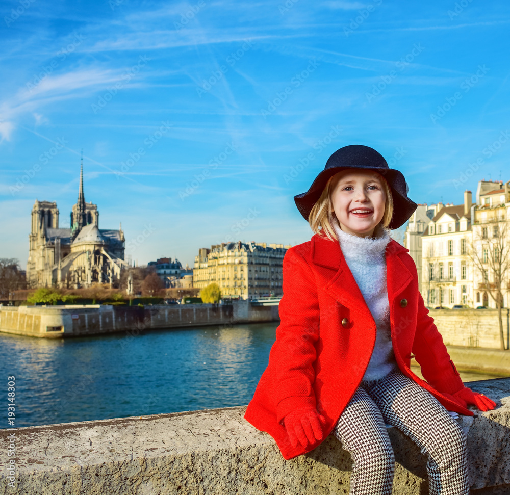 happy modern child on embankment in Paris, France relaxing