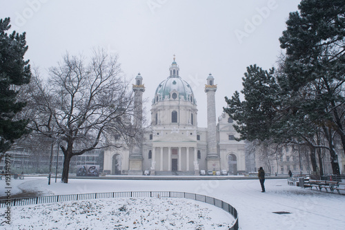 Snow covered grounds in front of Karlskirche in the city of Vienna, Austria