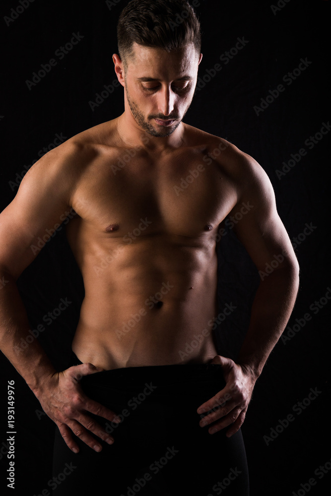 Fitness session in madrid's photographic studio with a boy without a shirt