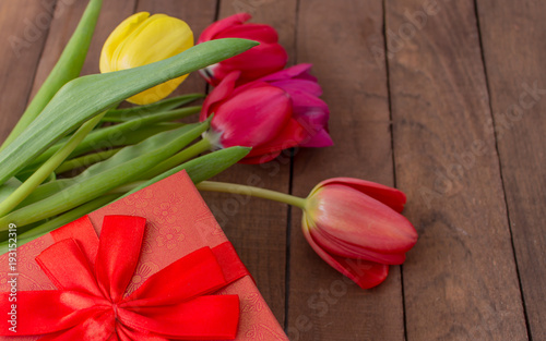 bouquet of tulips with a red gift
