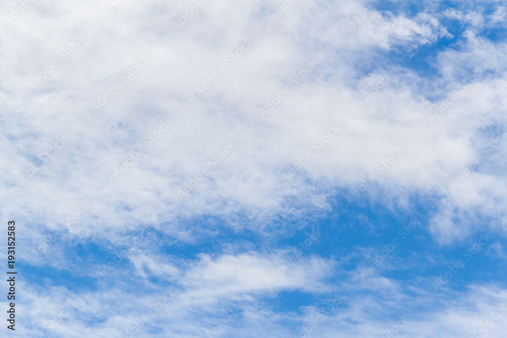 Blue sky background with white fluffy clouds