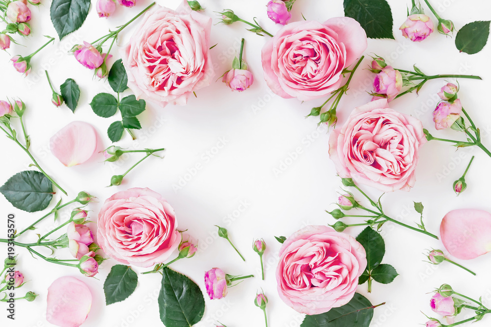 Flower frame with pink roses, buds and leaves on white background. Flat lay, top view. Spring frame background Flower frame with pink roses, buds and leaves on white background. Flat lay, top view. Spring frame background