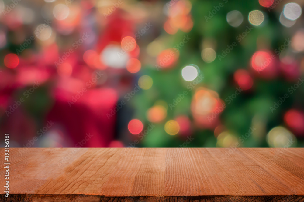 Wood table top on blur Christmas tree background - can be used for display or montage your products Wood table top on blur Christmas tree background - can be used for display or montage your products