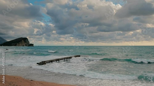 Lonely pier in the Adriatic Sea big waves photo