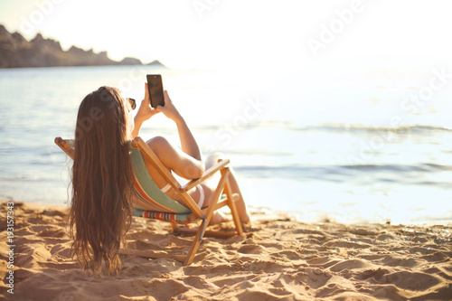 Girl chatting at the beach photo