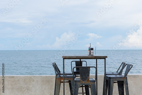 simple dinner table sea side ocean view nobody