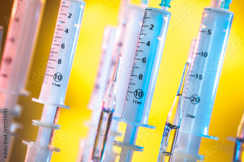 Syringes on a yellow backgr...