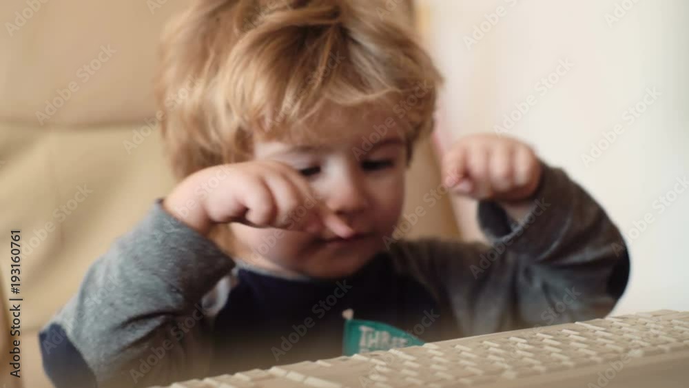 Little baby boy sitting with Laptop looking cartoons. Little boy learning to type on keyboard. Little baby boy sitting with Laptop looking cartoons. Little boy learning to type on keyboard.