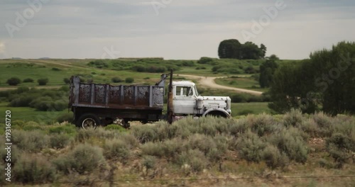 POV, traveling past old truck