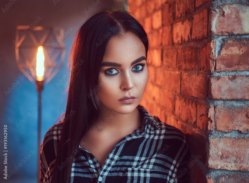 Portrait of an attractive brunette dressed in flannel shirt Portrait of an attractive brunette dressed in flannel shirt