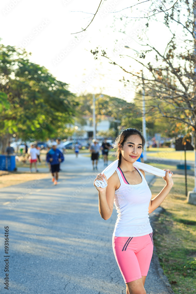 A women is exercising and relaxing at the park. A women is exercising and relaxing at the park.