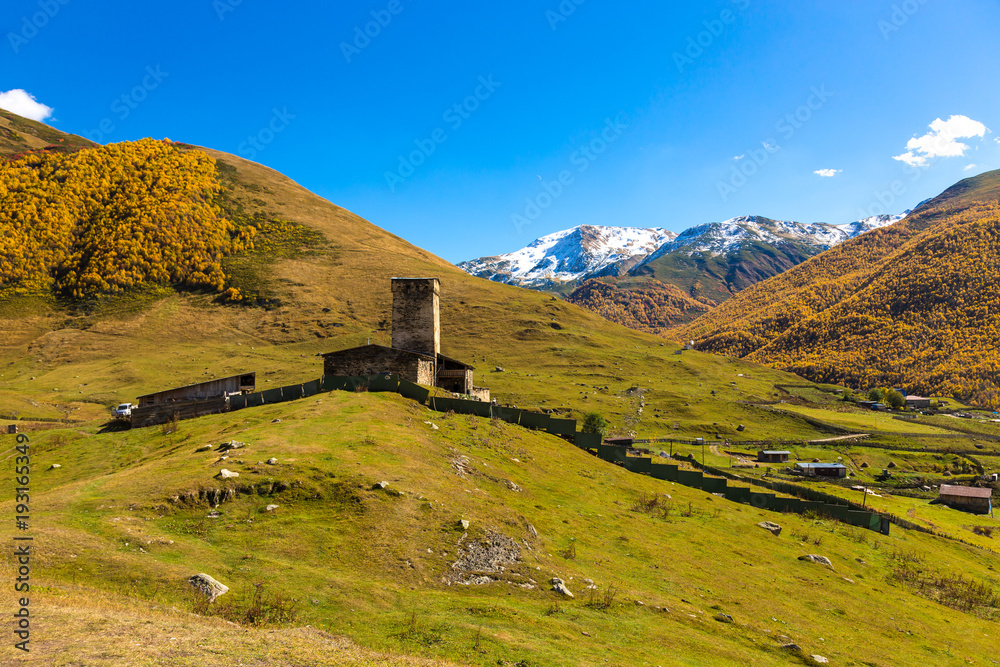 View of the village of Ushguli in a beautiful autumn landscape with white clouds in Svaneti. Georgia