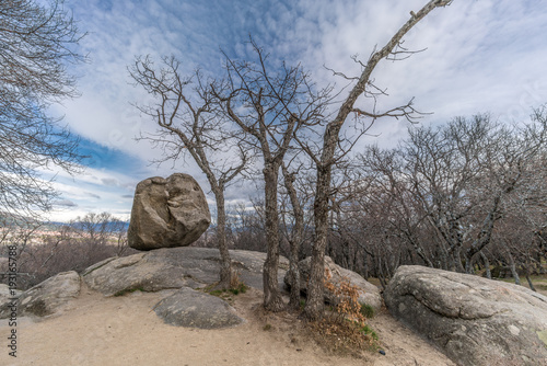 Celtic Vetton sacred place (Nemeton), Large boulder of granite rock surounded by trees at Silla de Felipe II (Phillip II chair) in Guadarrama Mountains near San Lorenzo del Escorial, Madrid, Spain photo