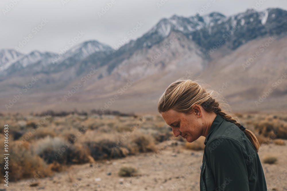Naklejka premium Blonde Woman with Braid in the Mountains
