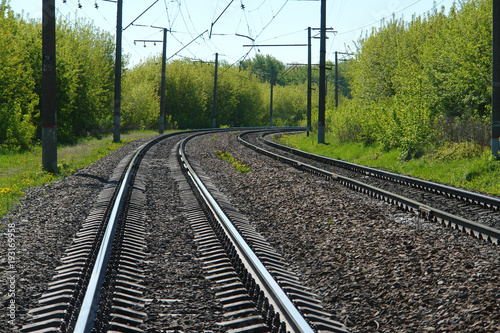 Rail lines on a green lands...