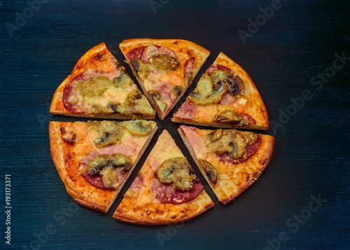 pizza on a dark wooden background