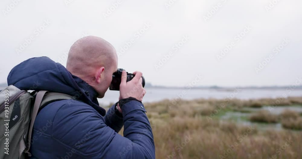 man traveling and hiking in nordic nature by lakes and in forest man traveling and hiking in nordic nature by lakes and in forest