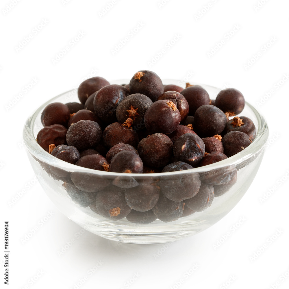 Fototapeta premium Dried juniper berries in glass bowl isolated on white.