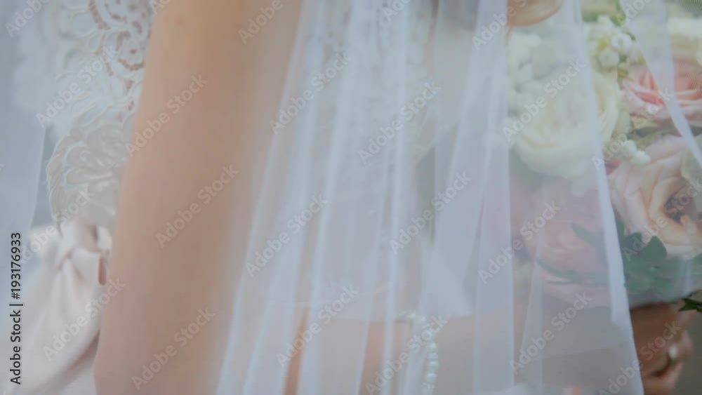 bride in a beautiful tender wedding dress is holding a wedding bouquet. tenderness love