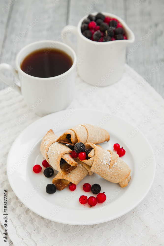 sweet bagels cookies and berries on a plate with two white cups sweet bagels cookies and berries on a plate with two white cups