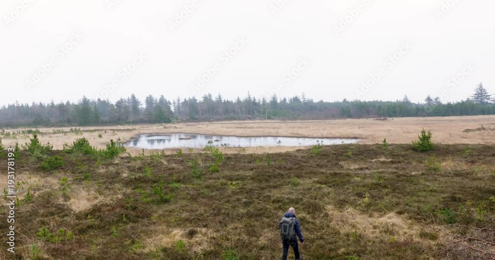 man traveling and hiking in nordic nature by lakes and in forest man traveling and hiking in nordic nature by lakes and in forest
