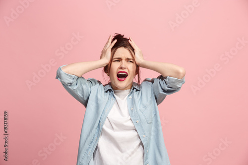Foto Beautiful woman in stress isolated on pink